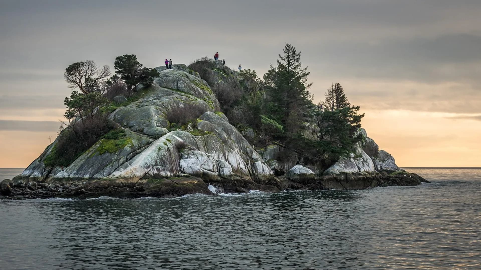 Whyte Islet off Whytecliff Park in West Vancouver at dusk, with walkers on the headland
